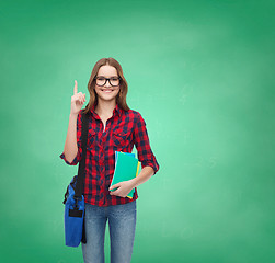Image showing smiling female student with bag and notebooks