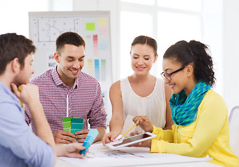 Image showing smiling interior designers working in office