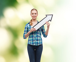 Image showing smiling young woman with arrow poiting up