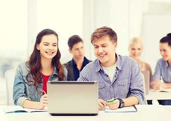 Image showing students with laptop and notebooks at school