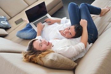 Image showing young couple using laptop at home