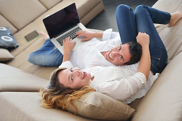 Image showing young couple using laptop at home