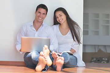 Image showing young couple using laptop at home