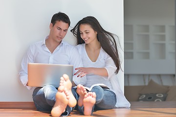 Image showing young couple using laptop at home