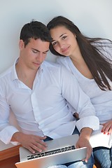 Image showing young couple using laptop at home