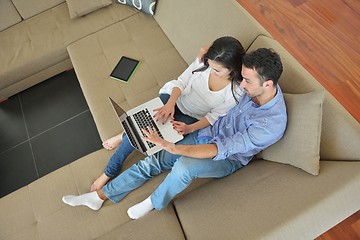 Image showing young couple using laptop at home