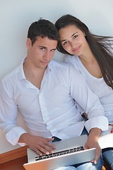 Image showing young couple using laptop at home