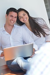 Image showing young couple using laptop at home