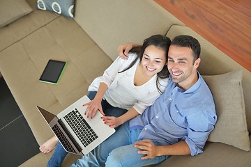 Image showing young couple using laptop at home