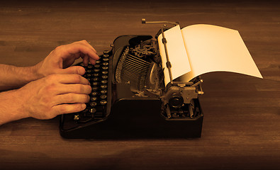 Image showing Writer or reporter behind the typewriter