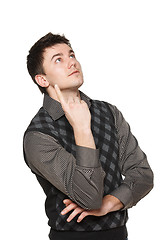 Image showing Surprised young man looking and pointing up