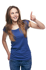 Image showing Smiling emotional girl pointing to the side