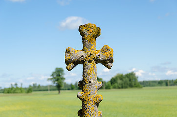 Image showing retro concrete cross on cloudy sky 