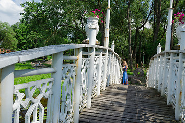 Image showing bridge wiggle railings and girl resting at bridge 