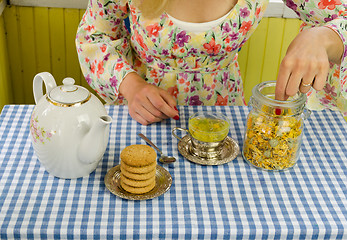 Image showing girl hand prepare marigold herb tea 