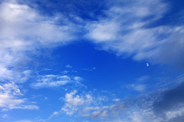 Image showing Evening blue sky with clouds and moon