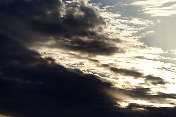 Image showing Dark storm clouds and sunlight sky