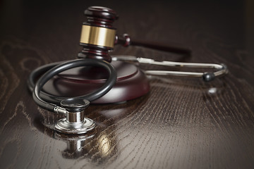 Image showing Gavel and Stethoscope on Reflective Table