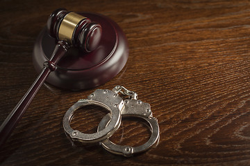 Image showing Gavel and Pair of Handcuffs on Table