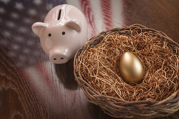 Image showing Golden Egg, Nest and Piggy Bank with American Flag Reflection