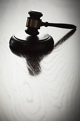 Image showing Dramatic Gavel Silhouette on Reflective Wood