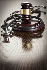 Image showing Gavel and Stethoscope on Reflective Table