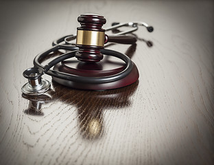 Image showing Gavel and Stethoscope on Reflective Table