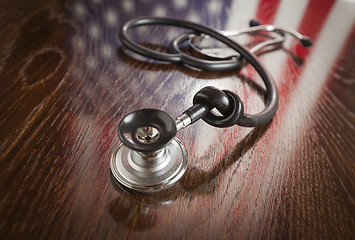 Image showing Knotted Stethoscope with American Flag Reflection on Table