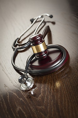 Image showing Gavel and Stethoscope on Reflective Table