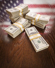 Image showing Thousands of Dollars with Reflection of American Flag on Table