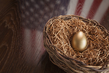 Image showing Golden Egg in Nest with American Flag Reflection on Table