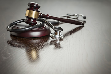 Image showing Gavel and Stethoscope on Reflective Table