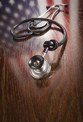 Image showing Knotted Stethoscope with American Flag Reflection on Table