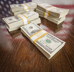 Image showing Thousands of Dollars with Reflection of American Flag on Table