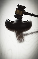 Image showing Dramatic Gavel Silhouette on Reflective Wood