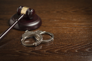 Image showing Gavel and Pair of Handcuffs on Table