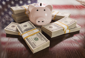 Image showing Thousands of Dollars, Piggy Bank, American Flag Reflection on Ta