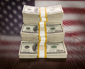 Image showing Thousands of Dollars with Reflection of American Flag on Table