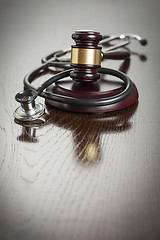 Image showing Gavel and Stethoscope on Reflective Table