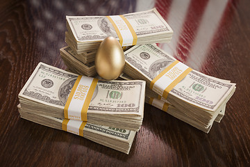 Image showing Golden Egg and Thousands of Dollars with American Flag Reflectio