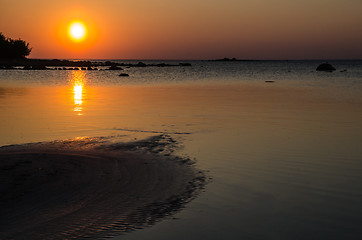 Image showing Sand formations at sunset at a calm bay