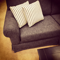 Image showing Gray sofa with striped white cushions