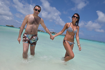 Image showing happy young couple have fun on beach