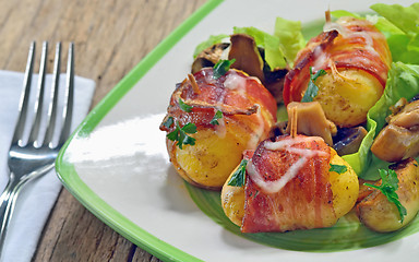 Image showing Baked potatoes wrapped in bacon