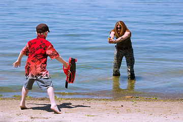 Image showing Mother and Son playing at the beach