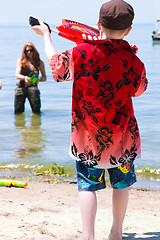 Image showing Mother and Son playing at the beach