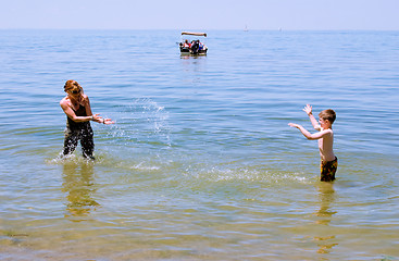 Image showing Mother and Son playing at the beach