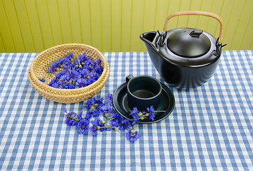 Image showing fresh cornflower tea set on blue white tablecloth 