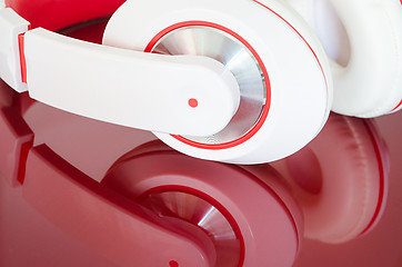 Image showing White red headphones on vinous surface 