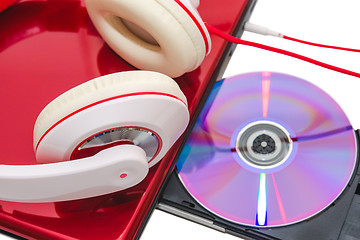 Image showing Portable computer with DVD disc and red white headphones